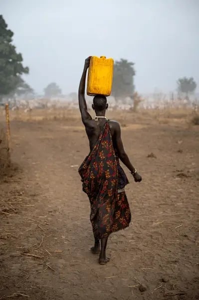 mundari-woman-water-canister-on-600nw-2468711647